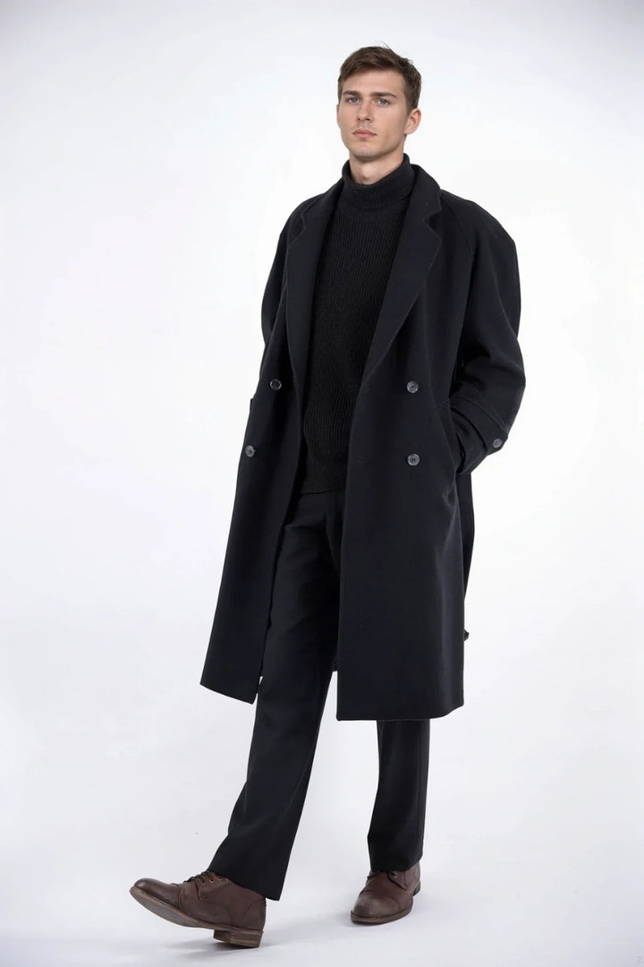 Men’s black overcoat styled with jeans and boots, ideal for casual winter outings.