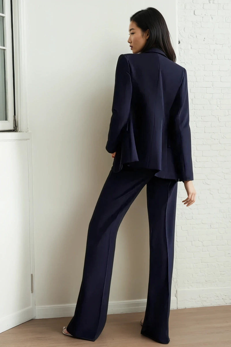 Close-up of black tuxedo blazer with satin peak lapels and button details
