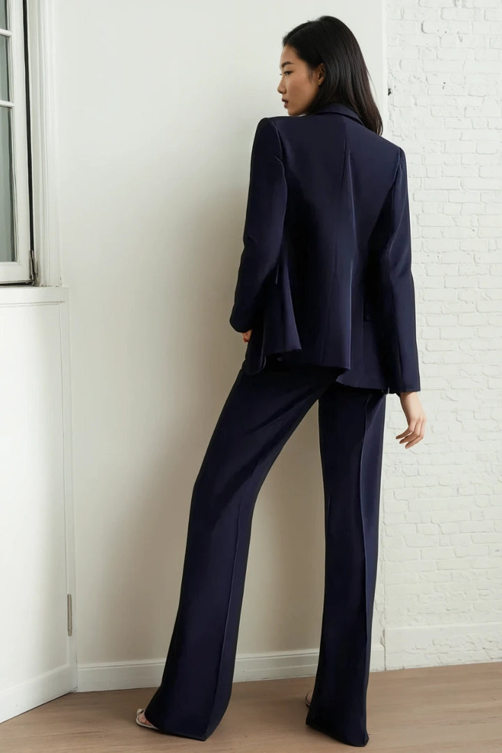 Close-up of black tuxedo blazer with satin peak lapels and button details