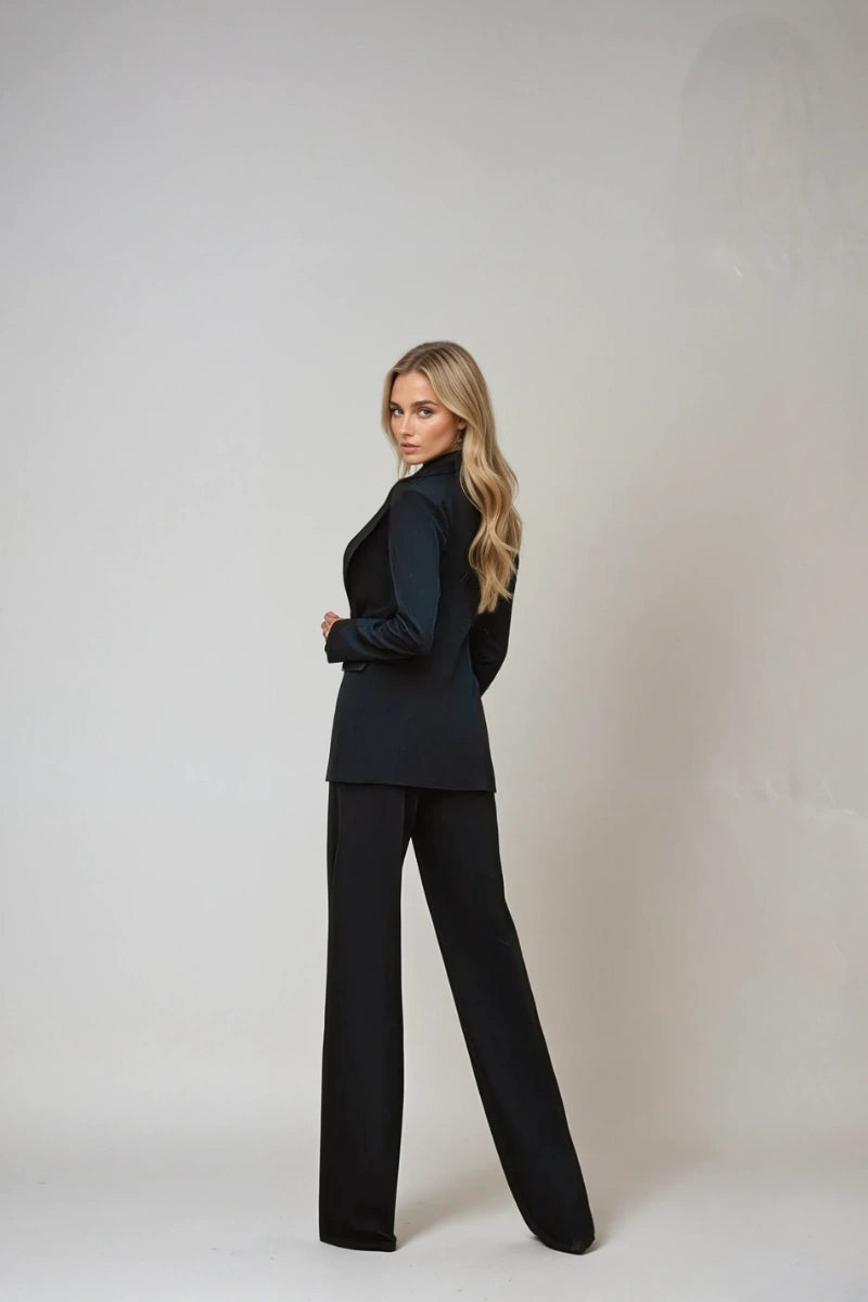 Women's black double-breasted suit highlighting tailored fit