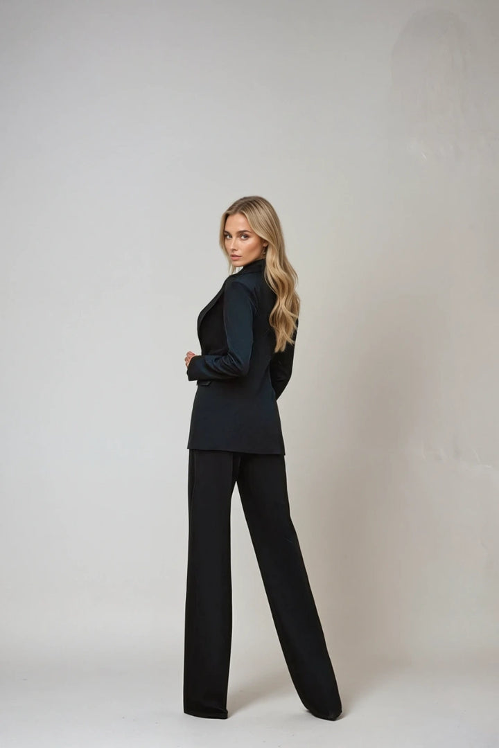 Women's black double-breasted suit highlighting tailored fit