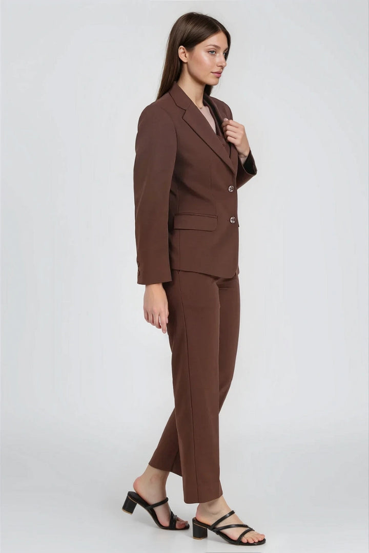 Close-up of brown formal blazer with peak lapel and button detail